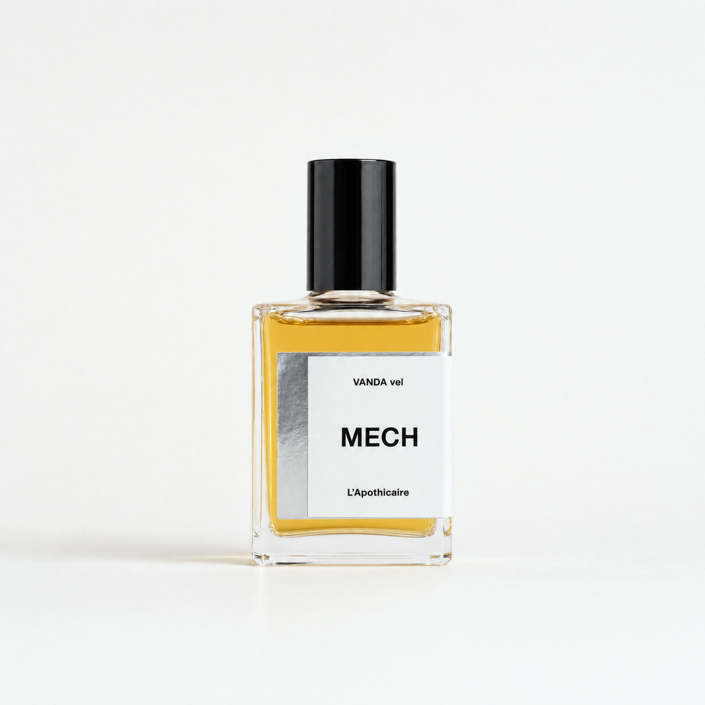 A rectangular glass perfume bottle with a black cap, filled with amber-yellow liquid, featuring a white label with the text 'WANDA vel MECH L'Apothicaire'.