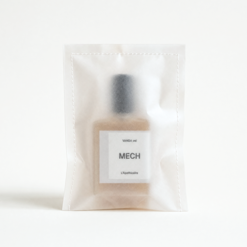 A small cosmetic bottle with a black cap and a white label reading 'WANDA vel' and 'MECH', sealed inside a translucent white drawstring pouch on a clean white background.