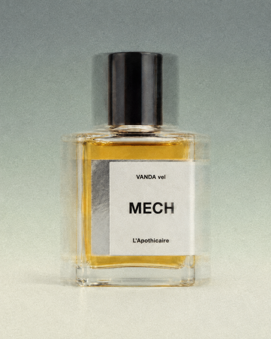 VANDA vel MECH perfume bottle photographed with soft blur and grain against a muted green background.